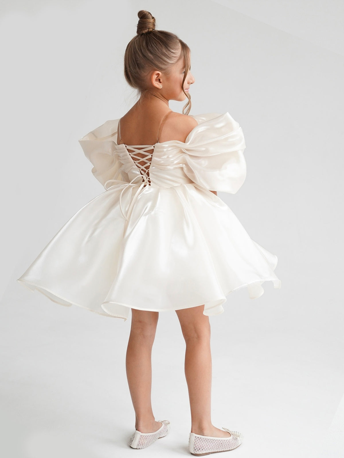 Satin off-shoulder puff sleeve ruched bodice lace-up back bubble hem mini flower girl dress - back view in ivory